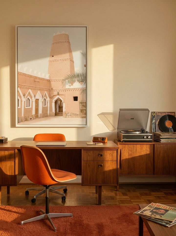 Canvas wall art with a white surround styled on the wall in a retro 70s home office