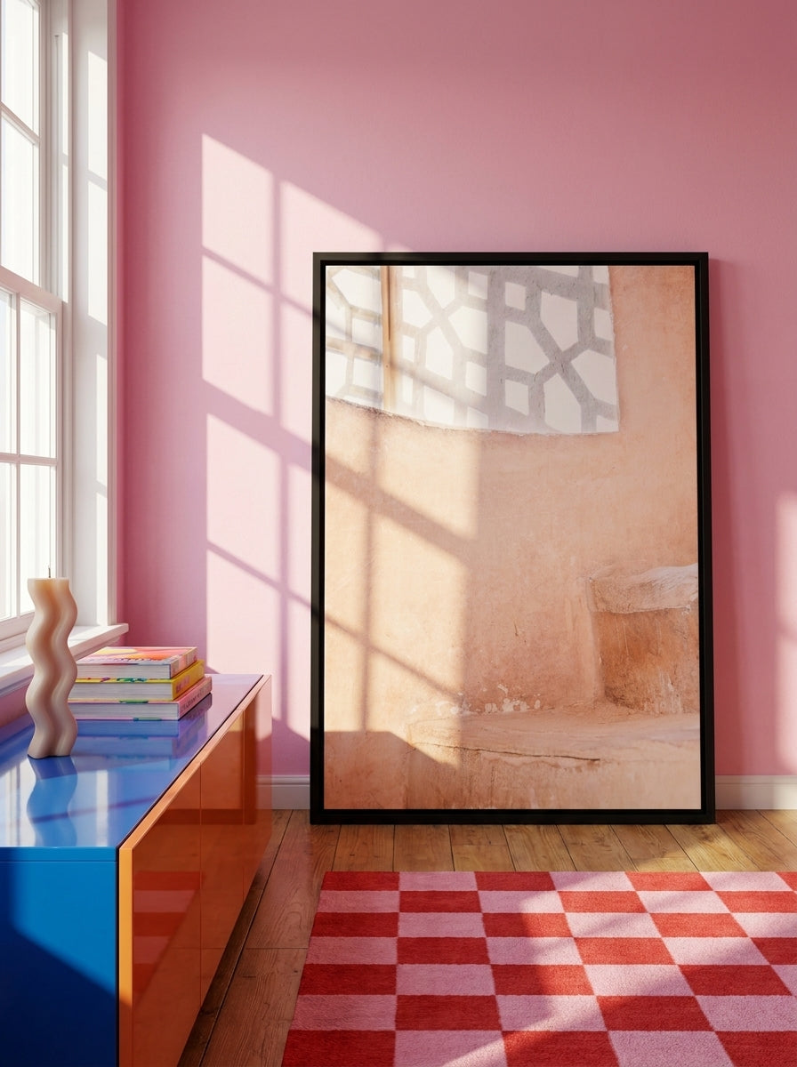 Canvas wall art with a black surround standing on a sideboard in a colourful eclectic bedroom