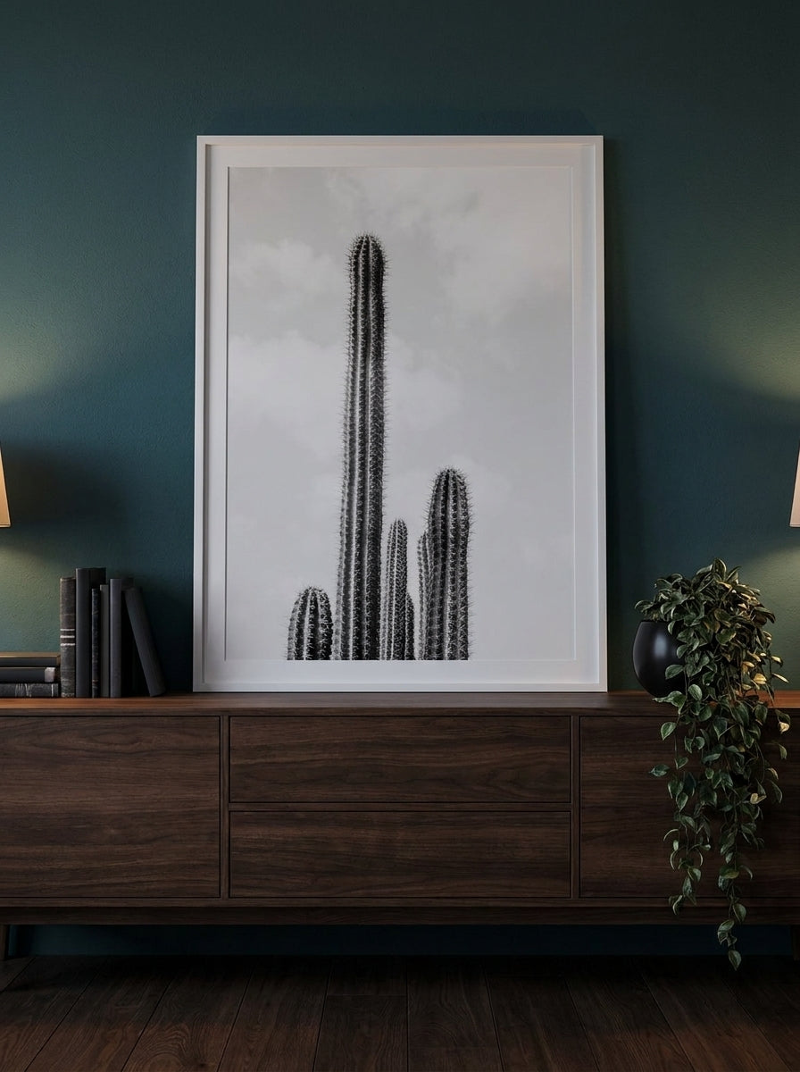 Modern wall art print standing on a sideboard in a moody bedroom
