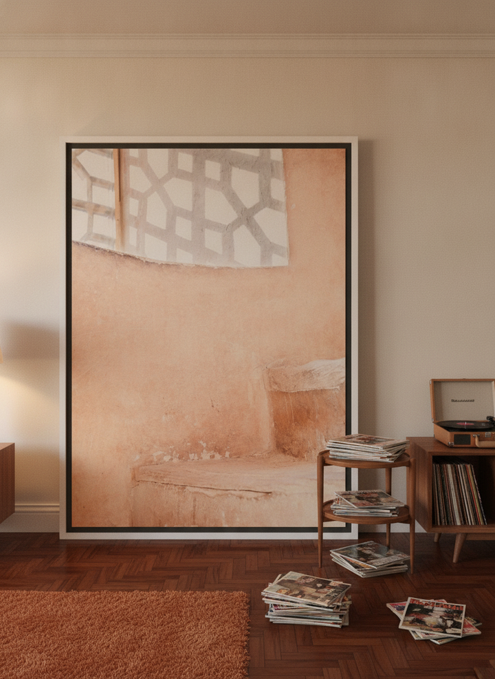 Oversized statement canvas wall art with a white surround leaning against the wall in a retro 70s living room