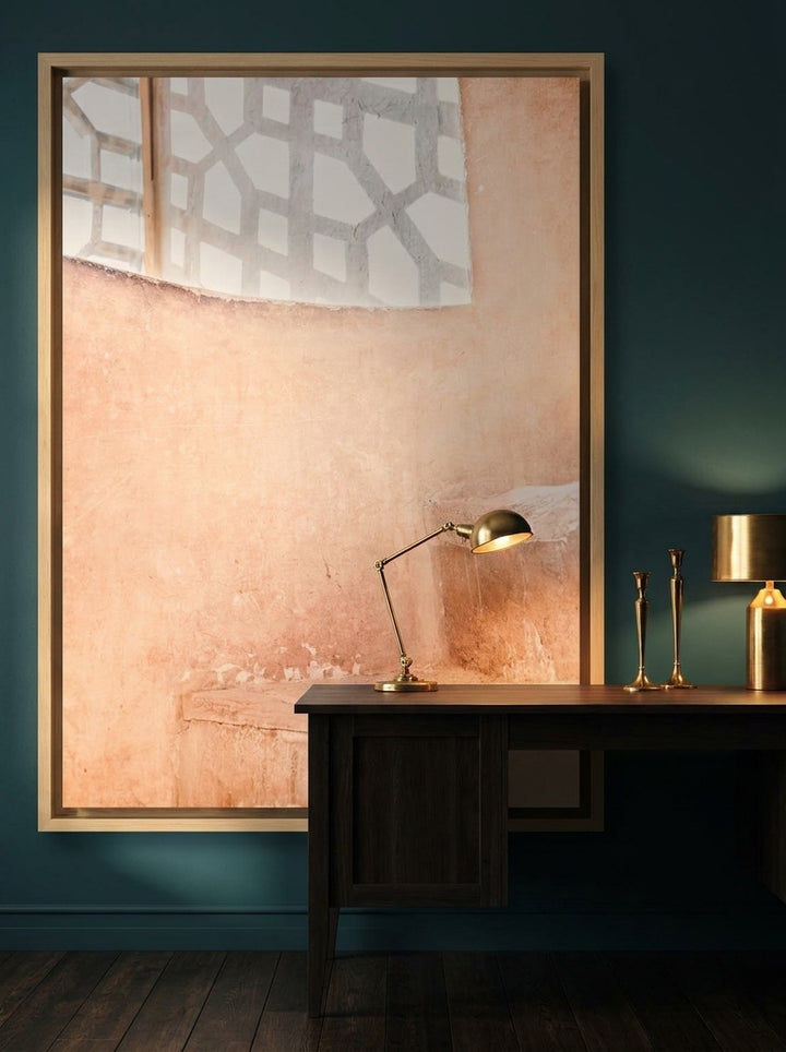 Oversized statement canvas wall art with a natural timber surround styled on the wall in a moody home office