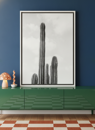 Canvas wall art with a white surround standing on a sideboard in a colourful eclectic bedroom
