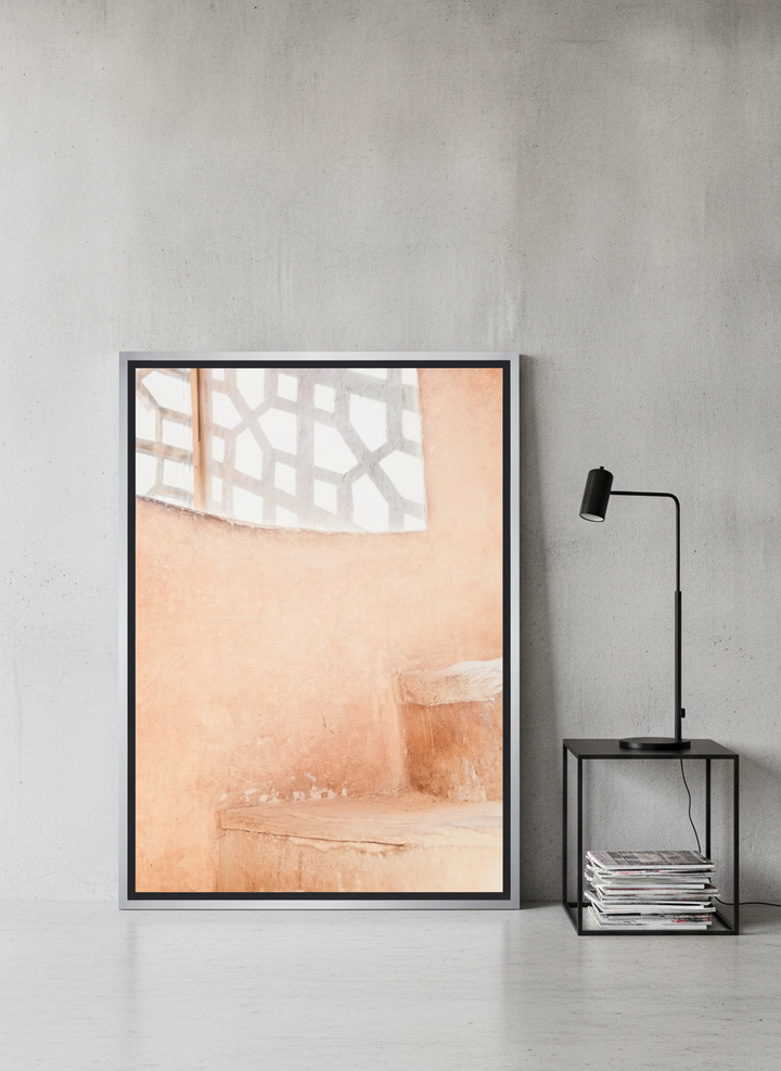 Canvas wall art with a silver leaf surround leaning against the wall in an industrial loft home office