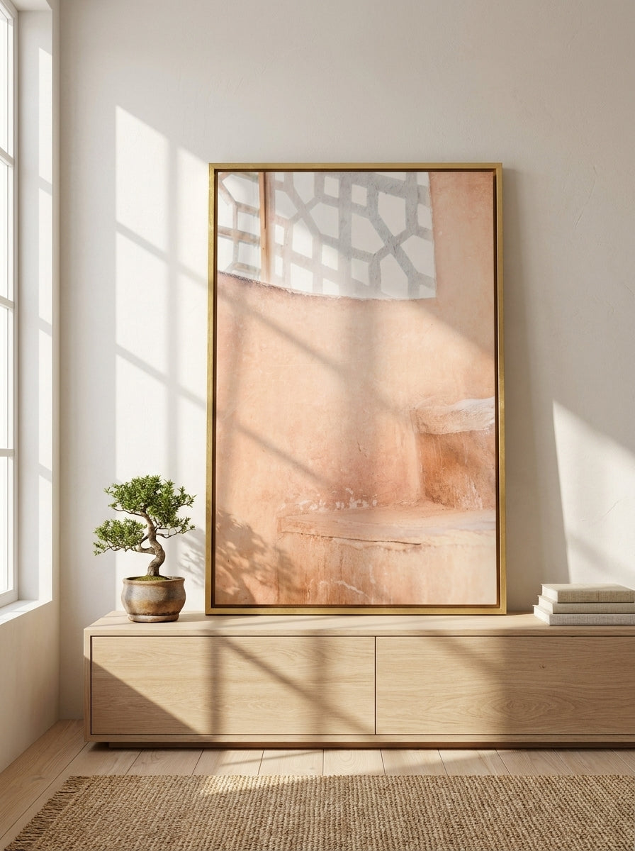 Canvas wall art with a gold leaf surround standing on a sideboard in a warm Japandi bathroom
