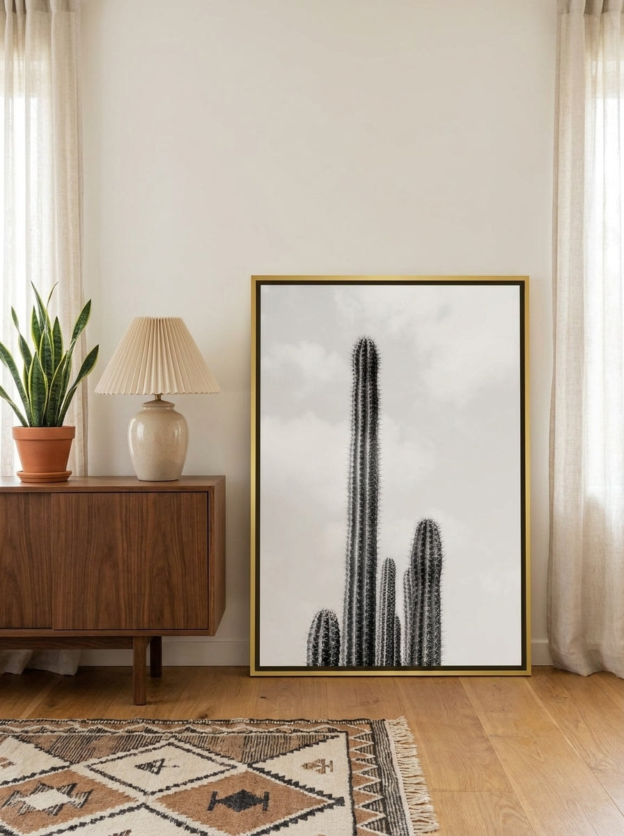 Canvas wall art with a gold leaf surround standing on a sideboard in a mid-century home office