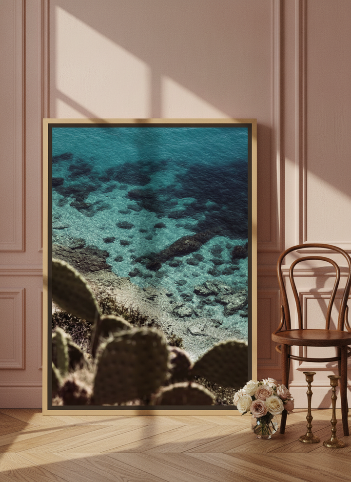 Oversized statement canvas wall art with a natural timber surround leaning against the wall in a Parisian bathroom