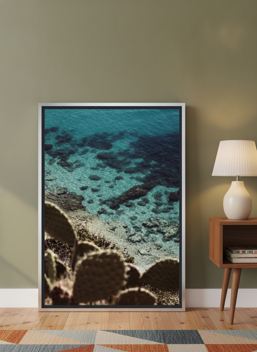 Canvas wall art with a silver leaf surround leaning against the wall in a mid-century living room