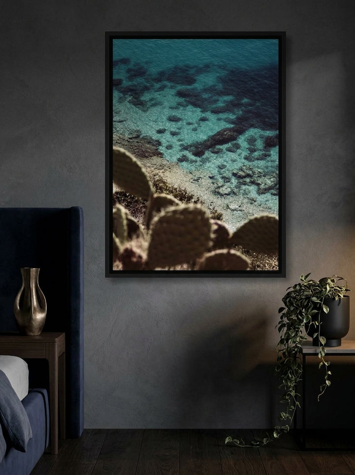 Canvas wall art with a black surround styled on the wall in a moody bedroom
