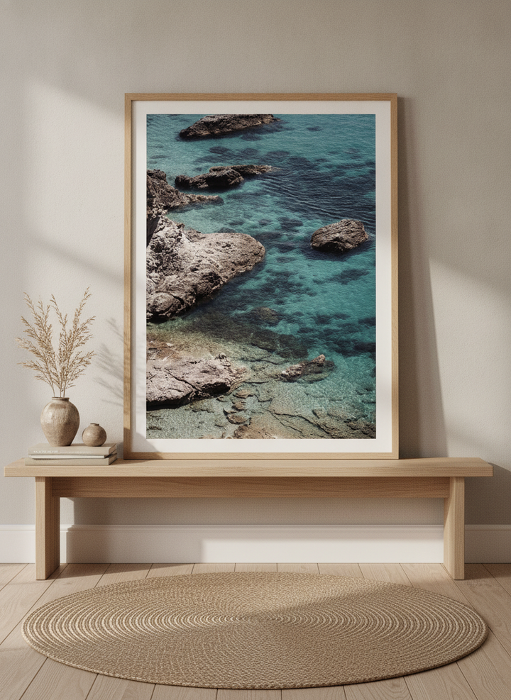 Modern wall art print standing on a bench in a warm Japandi bathroom