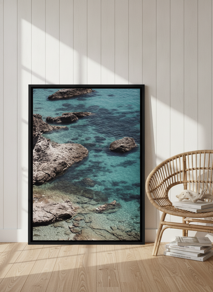 Canvas wall art with a black surround leaning against the wall in a coastal bathroom