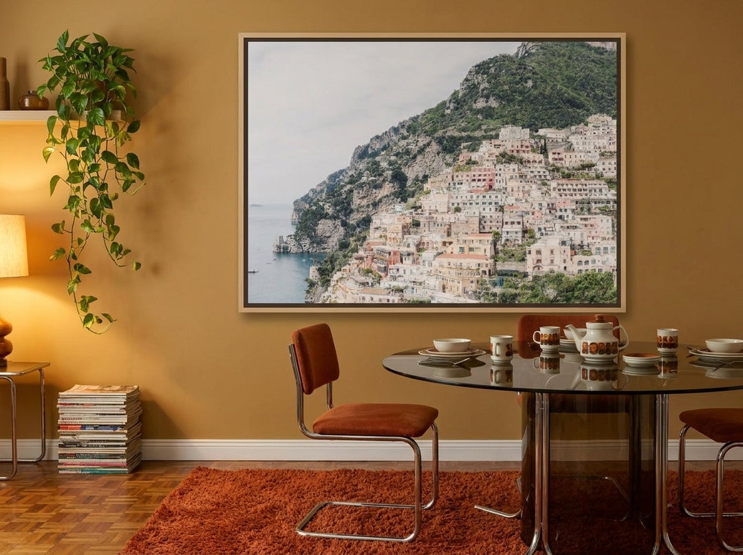 Oversized statement canvas wall art with a natural timber surround styled on the wall in a retro 70s dining room