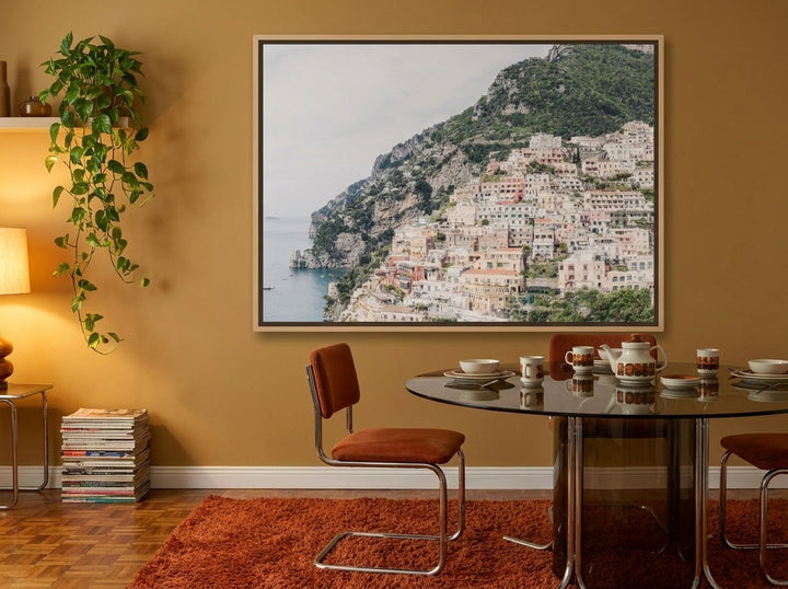 Oversized statement canvas wall art with a natural timber surround styled on the wall in a retro 70s dining room