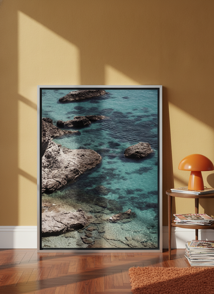 Canvas wall art with a silver leaf surround leaning against the wall in a retro 70s living room