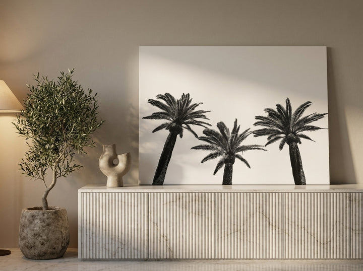 Stretched canvas wall art standing on a sideboard in a luxe home office