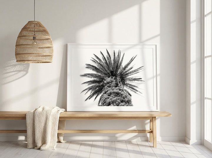 Modern wall art print standing on a bench in a bright Scandinavian home office