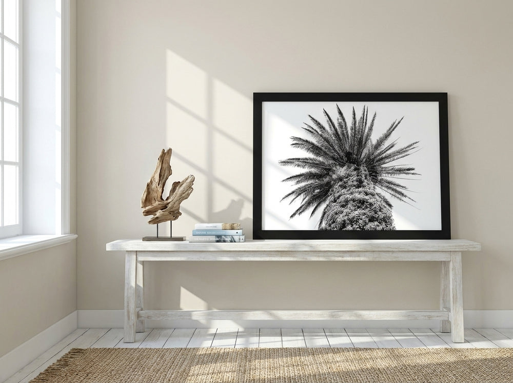 Modern wall art print standing on a console in a coastal bedroom