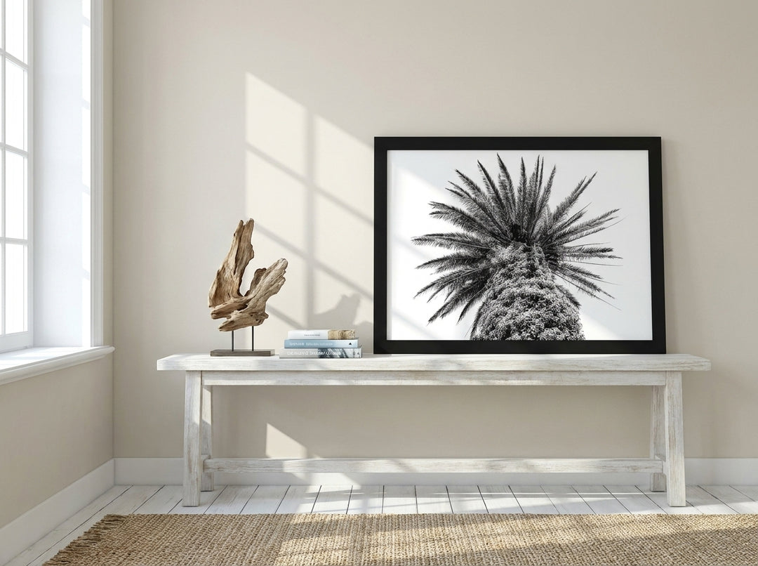 Modern wall art print standing on a console in a coastal bedroom