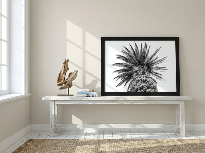 Modern wall art print standing on a console in a coastal bedroom