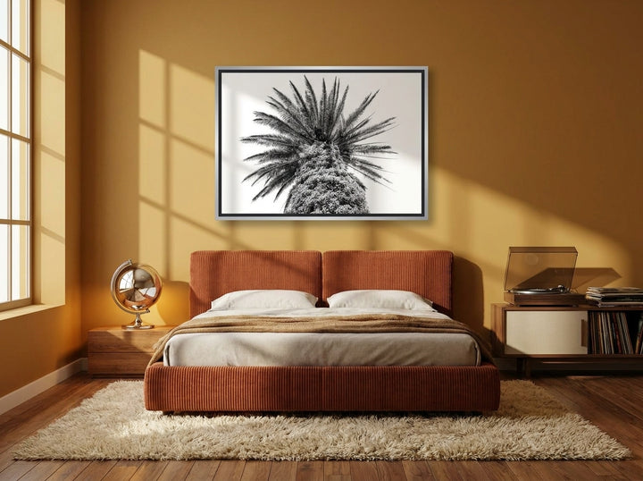 Canvas wall art with a silver leaf surround styled on the wall in a retro 70s bedroom