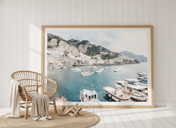 Oversized statement modern wall art print leaning against the wall in a coastal bedroom