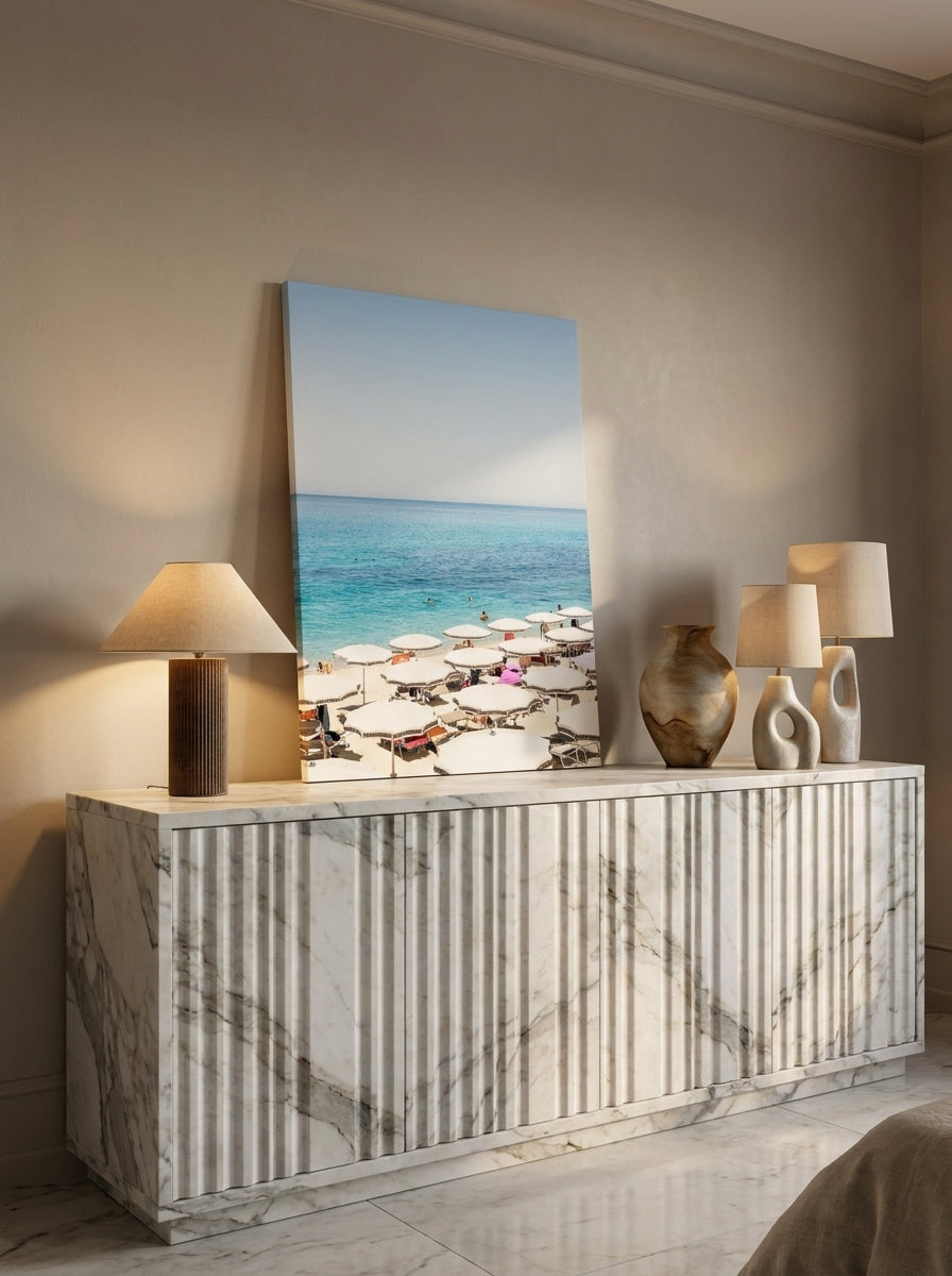 Stretched canvas wall art standing on a sideboard in a luxe bedroom