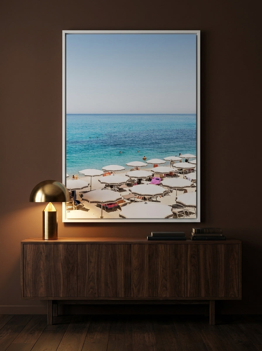 Oversized statement canvas wall art with a white surround styled on the wall in a moody living room