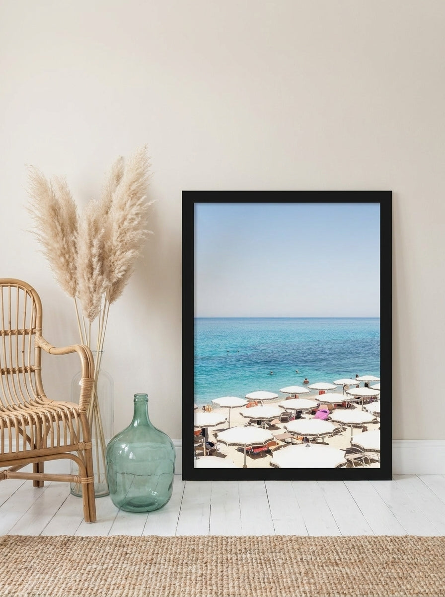 Modern wall art print leaning against the wall in a coastal bedroom
