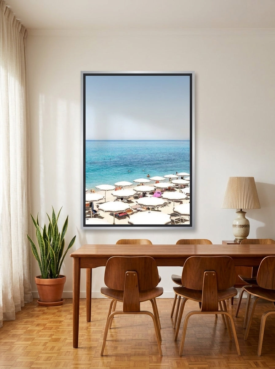 Canvas wall art with a silver leaf surround styled on the wall in a mid-century dining room