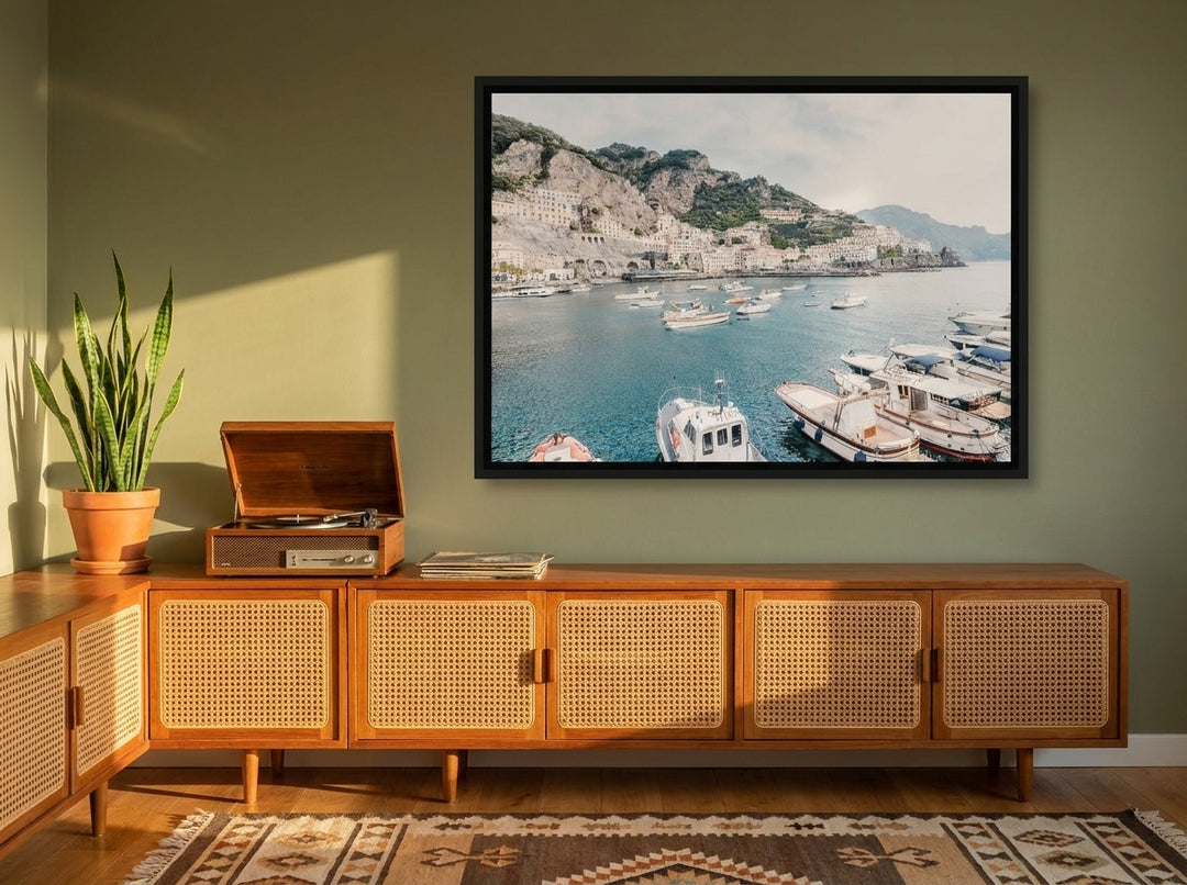 Canvas wall art with a black surround styled on the wall in a mid-century living room