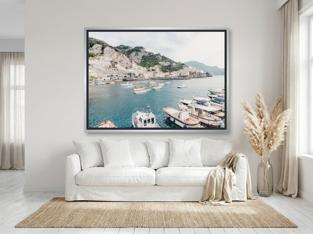 Oversized statement canvas wall art with a silver leaf surround styled on the wall in a coastal living room