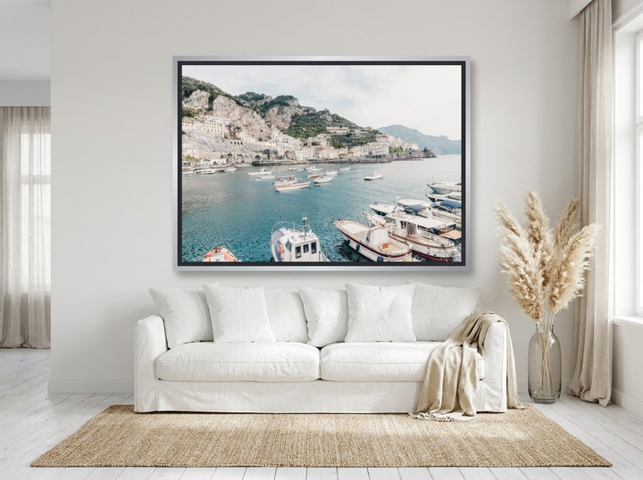 Oversized statement canvas wall art with a silver leaf surround styled on the wall in a coastal living room
