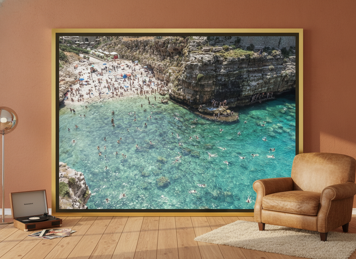 Oversized statement canvas wall art with a gold leaf surround leaning against the wall in a retro 70s living room