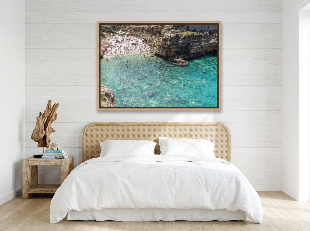 Oversized statement canvas wall art with a natural timber surround styled on the wall in a coastal bedroom