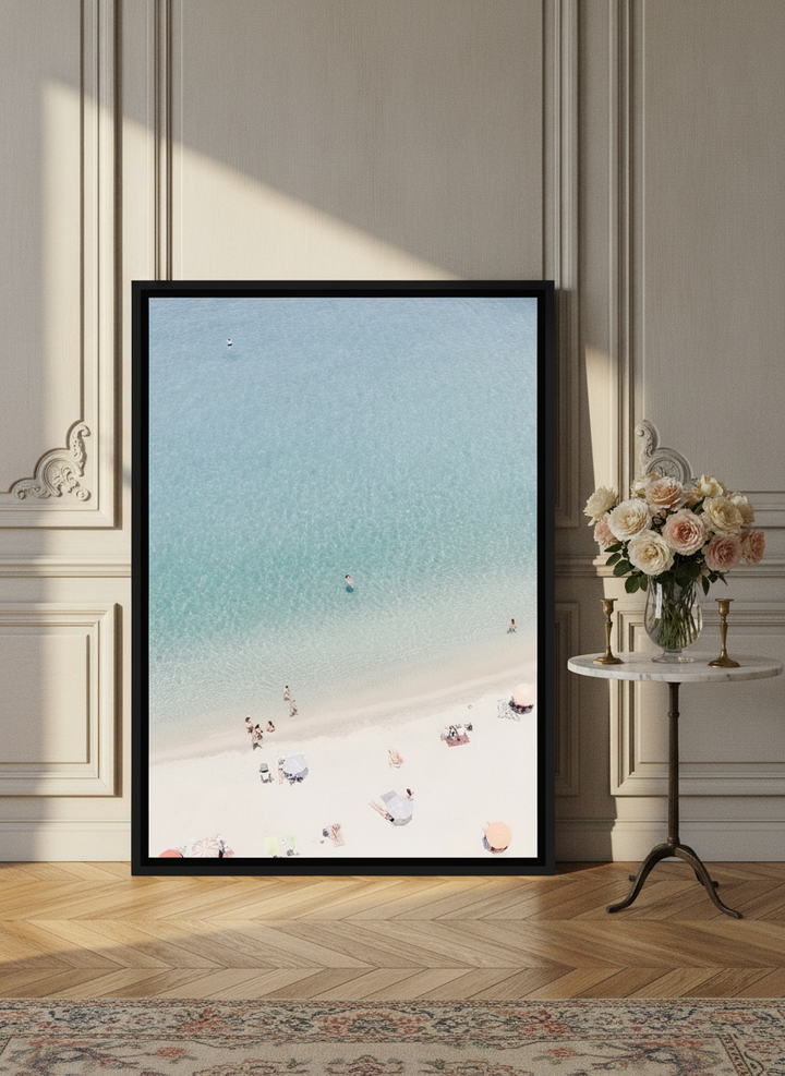 Canvas wall art with a black surround leaning against the wall in a Parisian bathroom