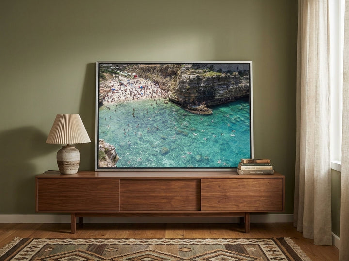 Canvas wall art with a silver leaf surround standing on a sideboard in a mid-century home office