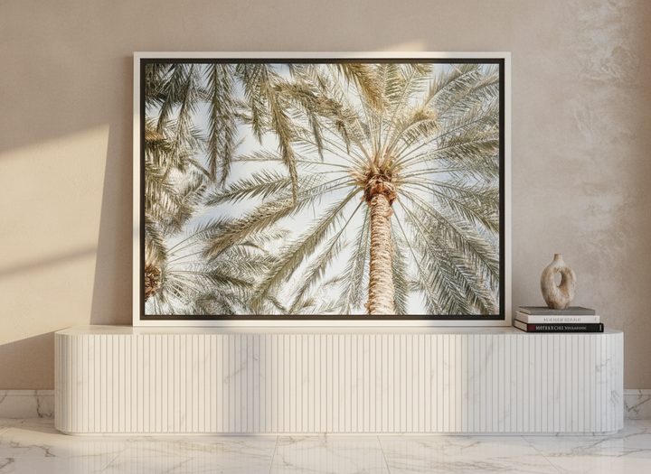 Canvas wall art with a white surround standing on a sideboard in a luxe home office