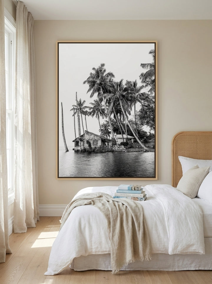 Oversized statement canvas wall art with a natural timber surround styled on the wall in a coastal bedroom