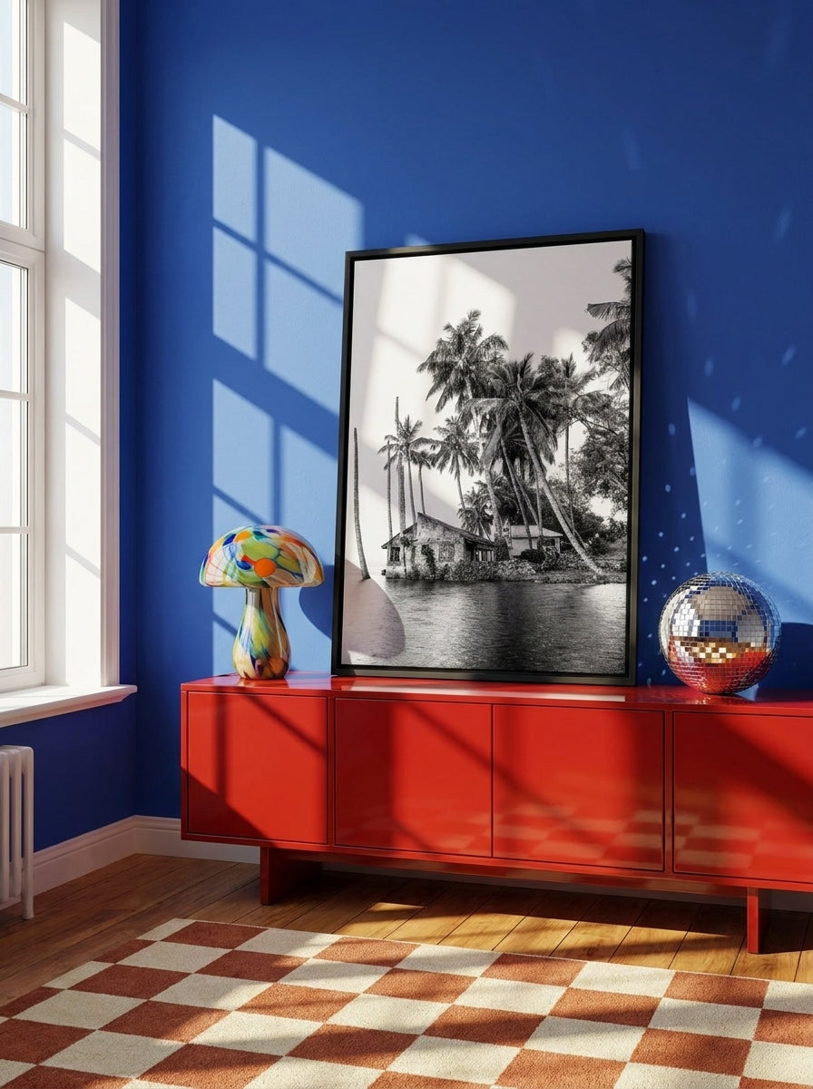 Canvas wall art with a black surround standing on a sideboard in a colourful eclectic living room