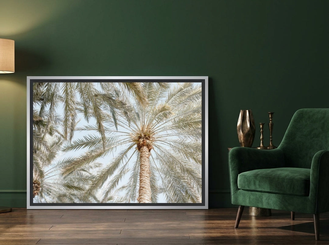 Canvas wall art with a silver leaf surround leaning against the wall in a moody living room
