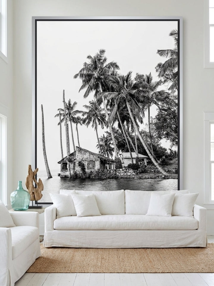 Oversized statement canvas wall art with a silver leaf surround styled on the wall in a coastal living room