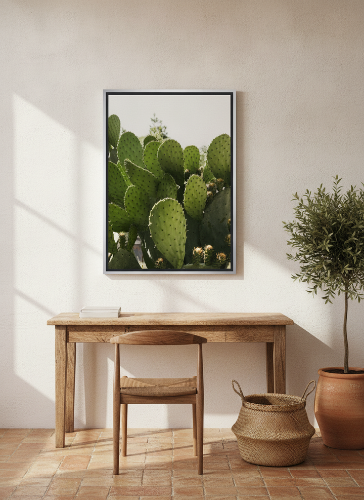 Canvas wall art with a silver leaf surround styled on the wall in a Mediterranean home office