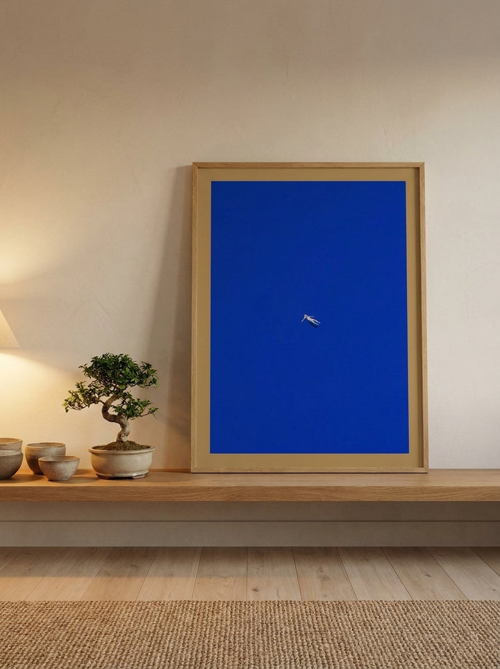 Modern wall art print standing on a shelf in a warm Japandi bedroom