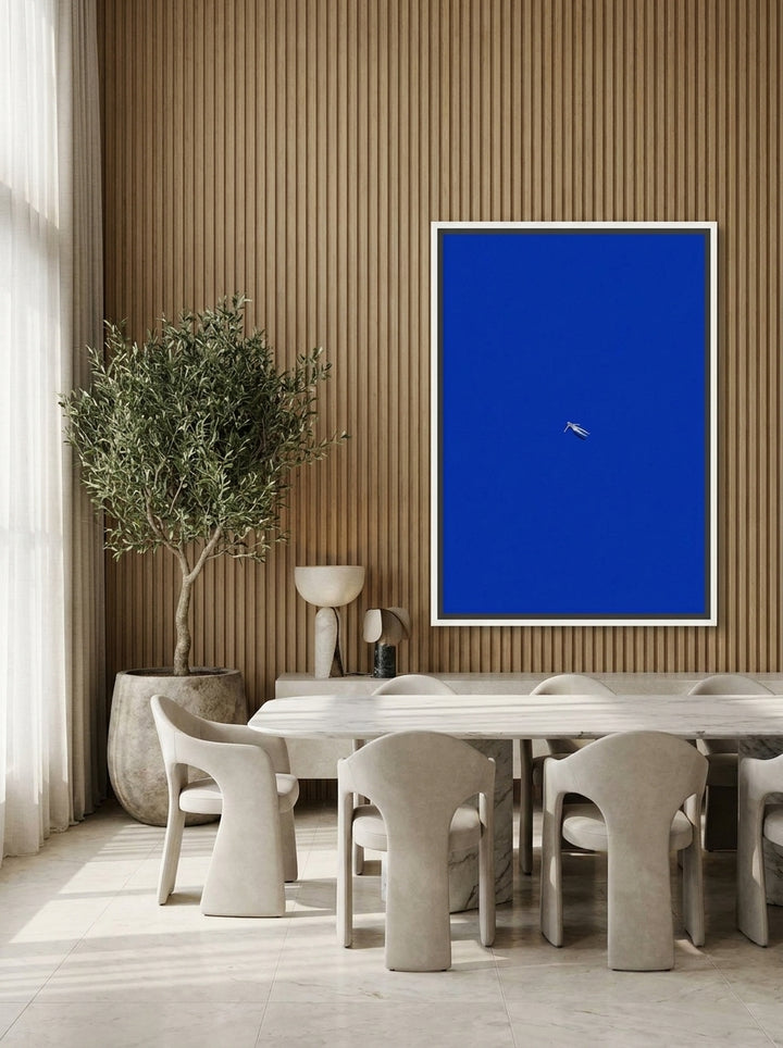 Oversized statement canvas wall art with a white surround styled on the wall in a luxe dining room