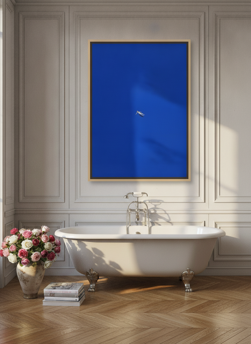 Oversized statement canvas wall art with a natural timber surround styled on the wall in a Parisian bathroom