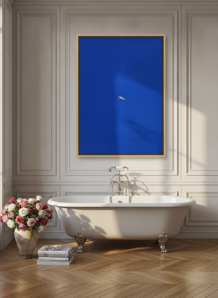 Oversized statement canvas wall art with a natural timber surround styled on the wall in a Parisian bathroom