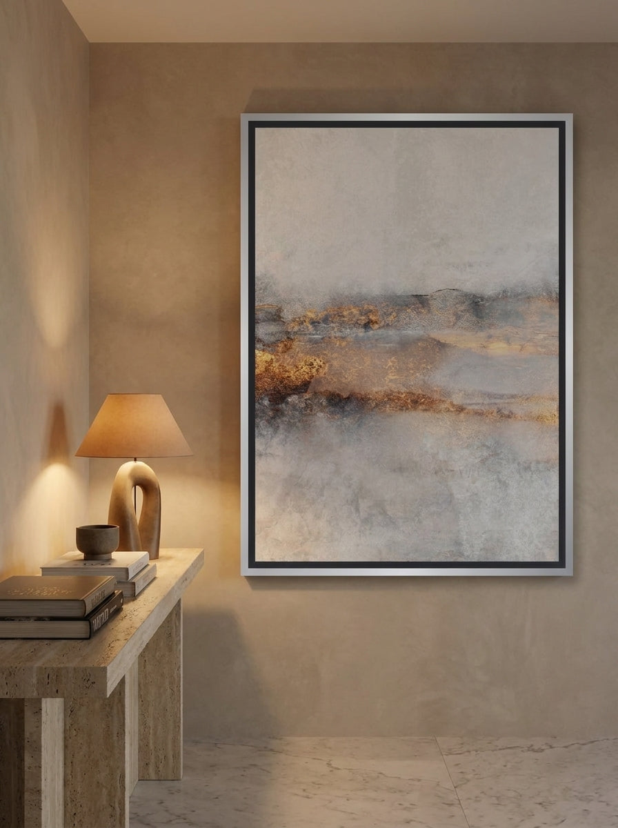 Oversized statement canvas wall art with a silver leaf surround styled on the wall in a luxe living room