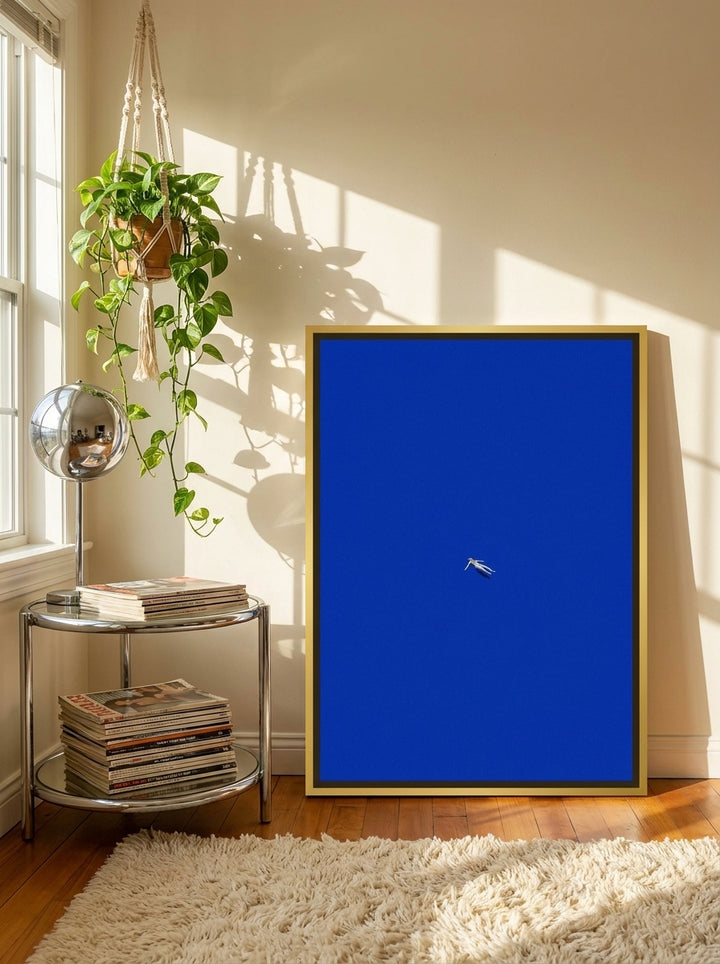 Canvas wall art with a gold leaf surround leaning against the wall in a retro 70s living room
