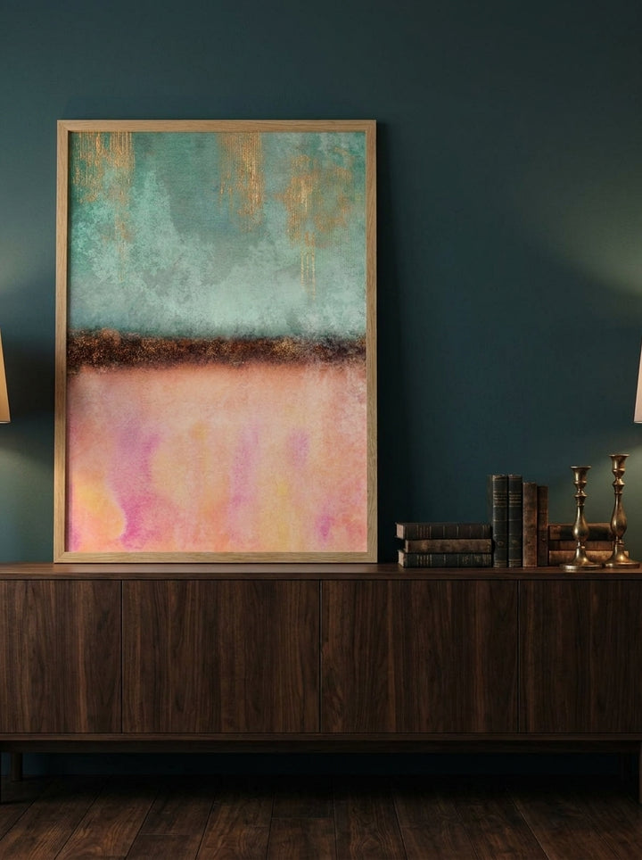 Modern wall art print standing on a sideboard in a moody home office