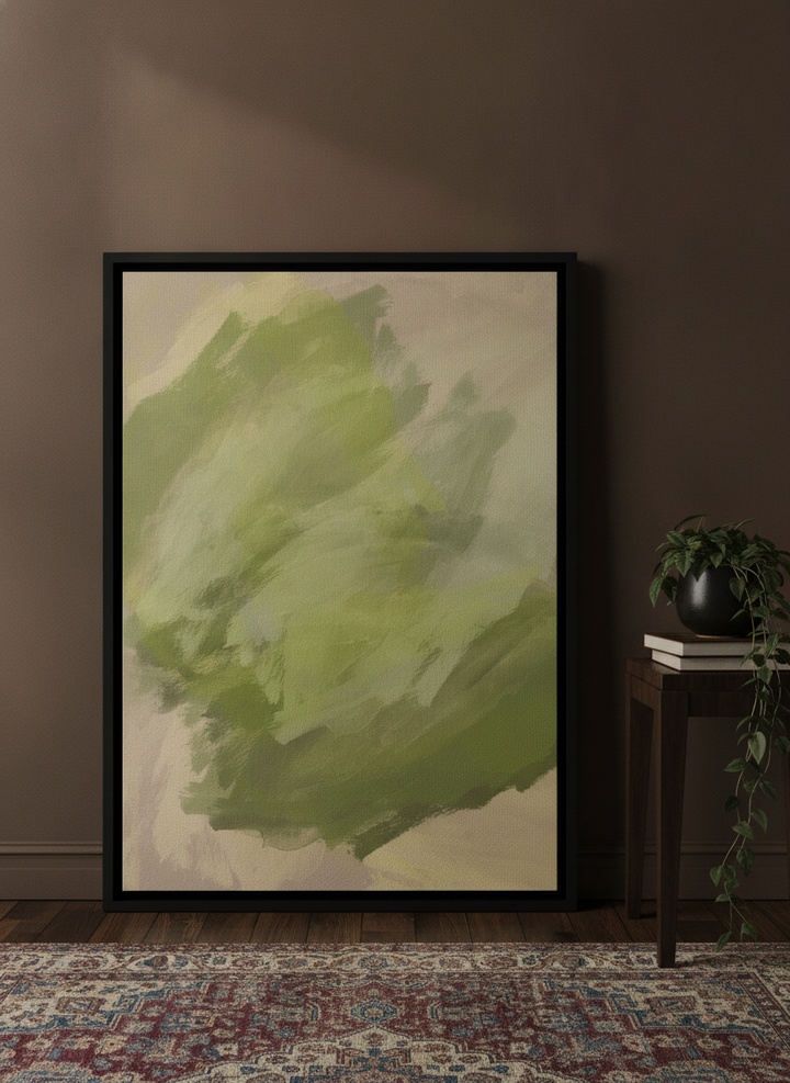 Canvas wall art with a black surround leaning against the wall in a moody living room