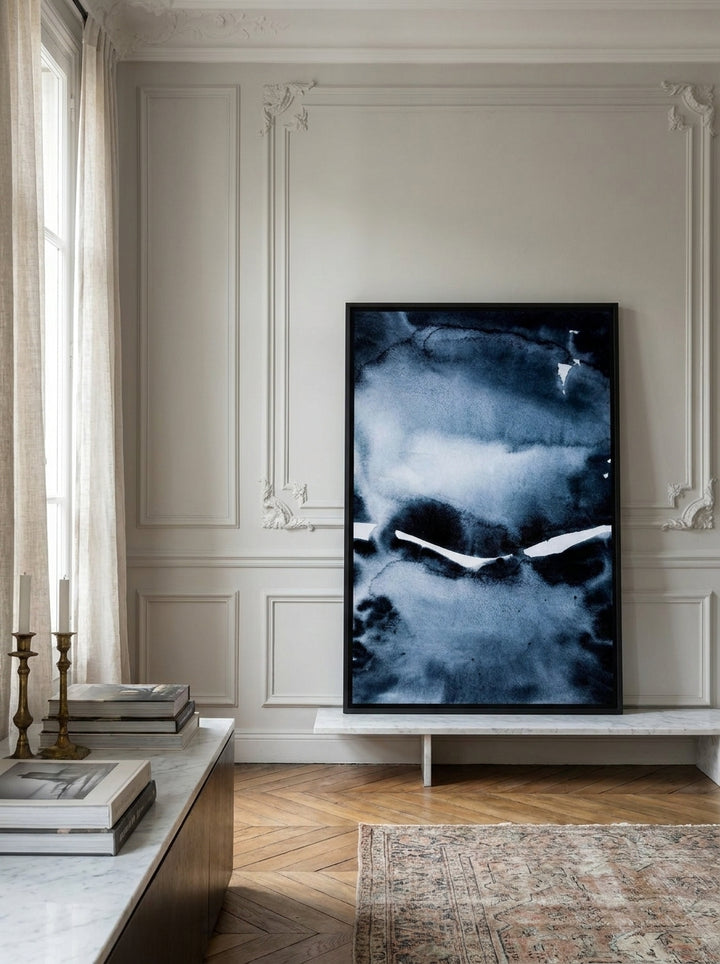 Canvas wall art with a black surround standing on a console in a Parisian living room